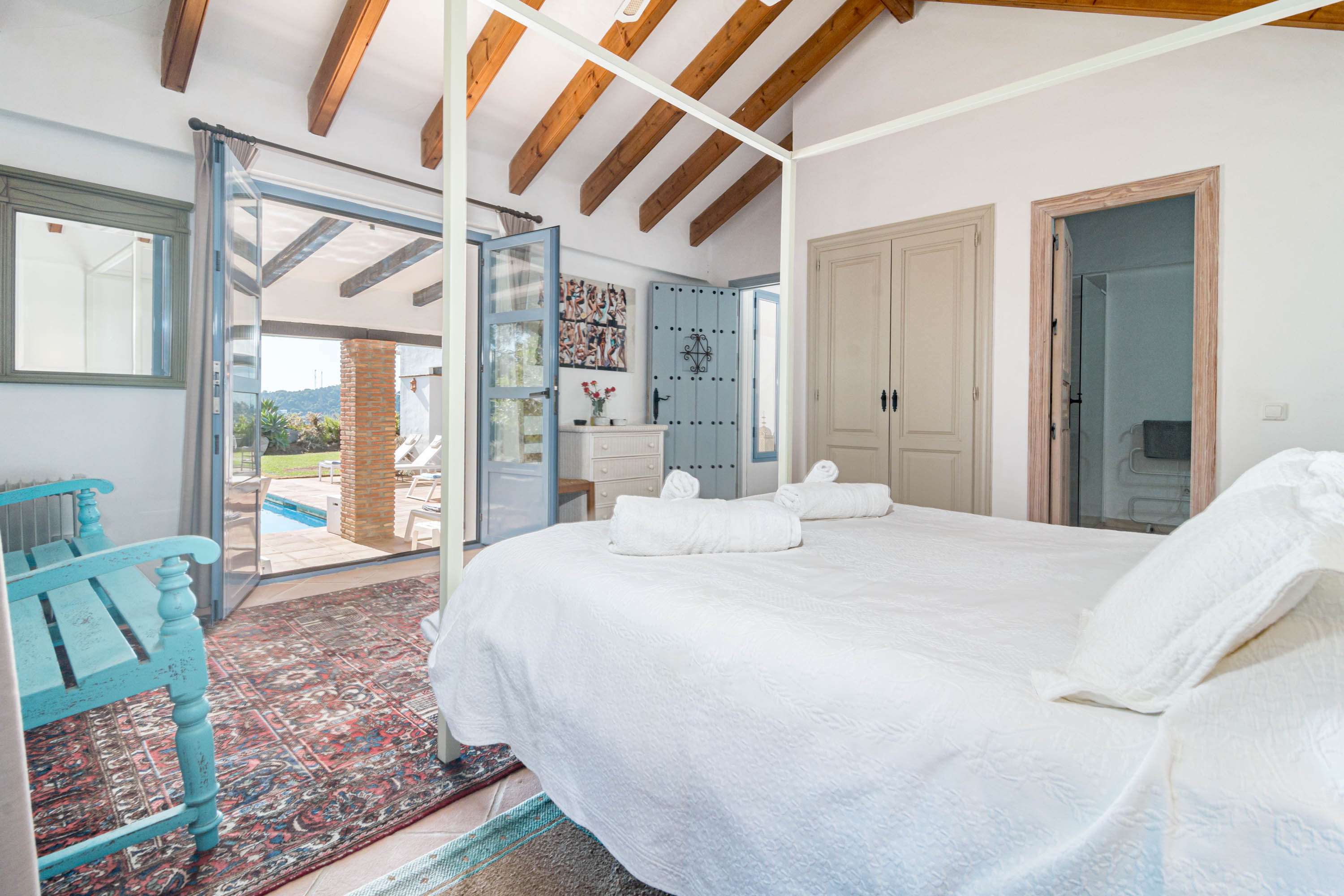 Bedroom 1 with en suite facilities and doors to patio